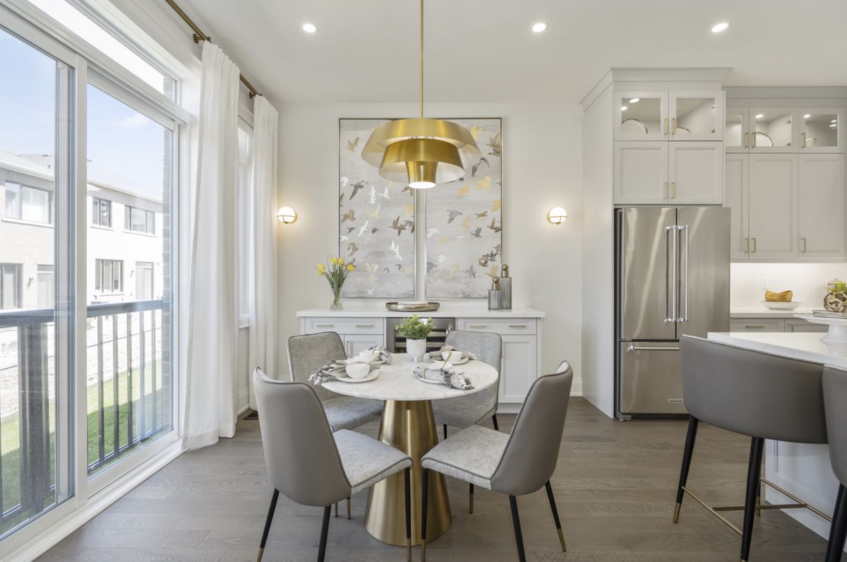 Bright breakfast area with brass pendant beside the kitchen